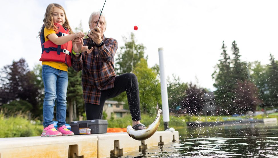 Grandpa and Granddaughter Catching a Fish